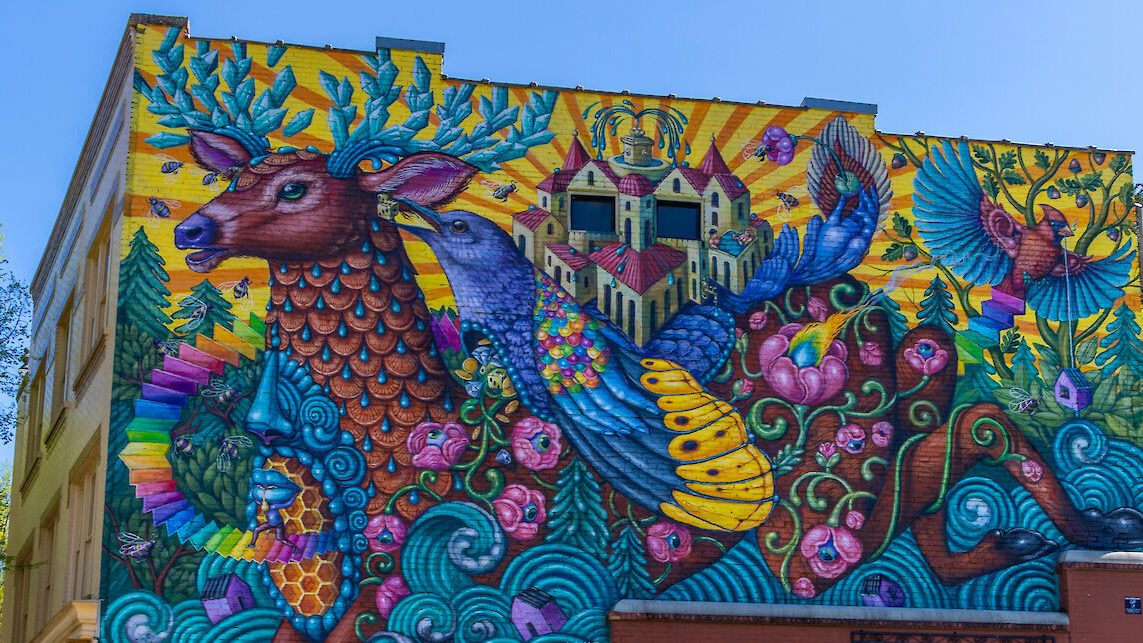 Colorful mural of a deer with crystal antlers and a crowned bird in Hot Springs, Arkansas