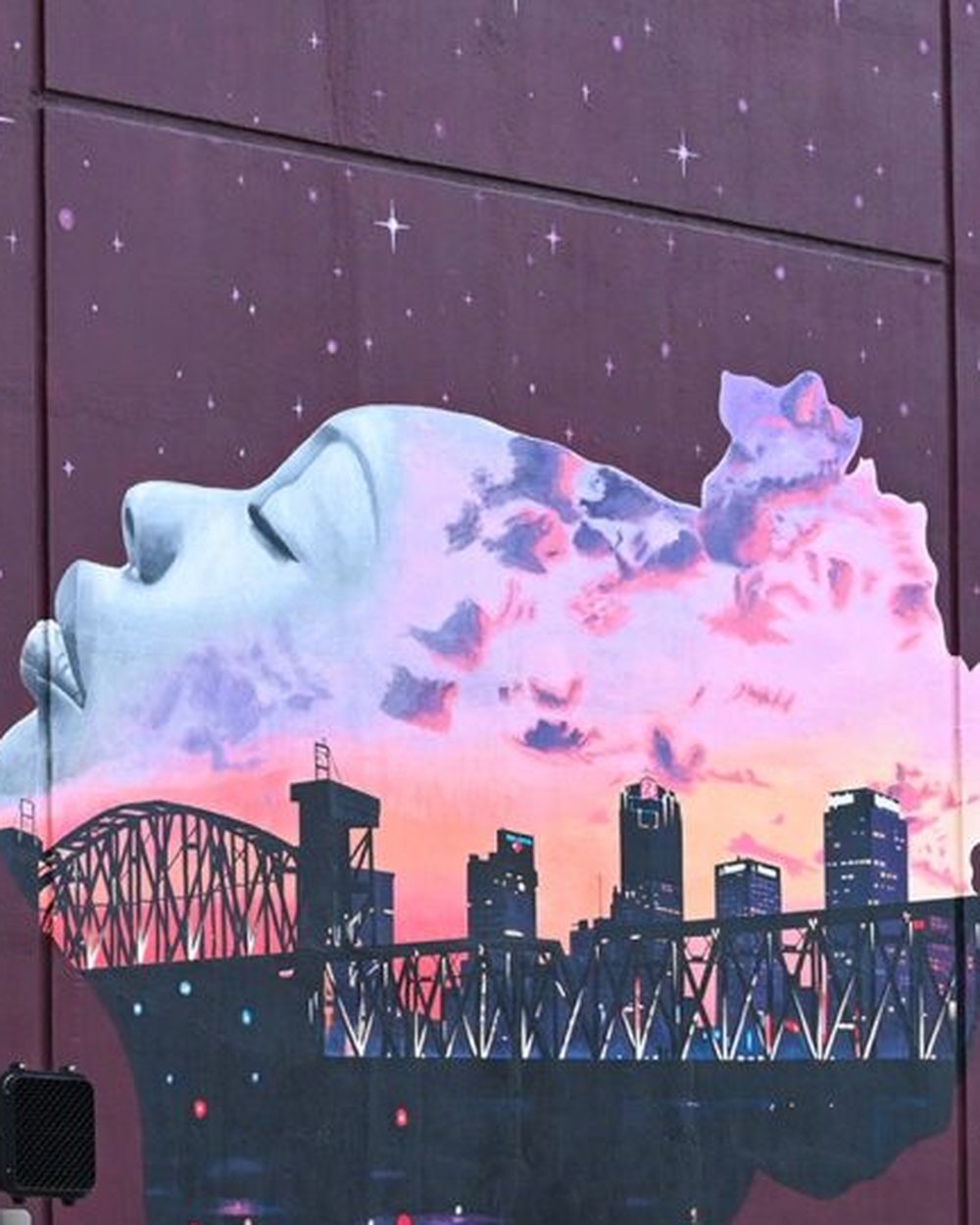 City Dreamers mural in Little Rock, Arkansas — a profile filled with the downtown skyline at sunset